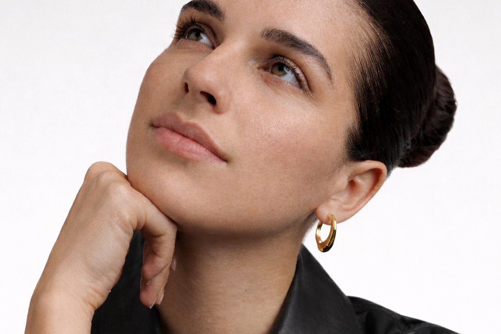 Woman wearing bold chunks gold earrings