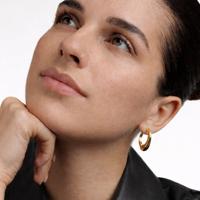 Woman wearing bold chunks gold earrings