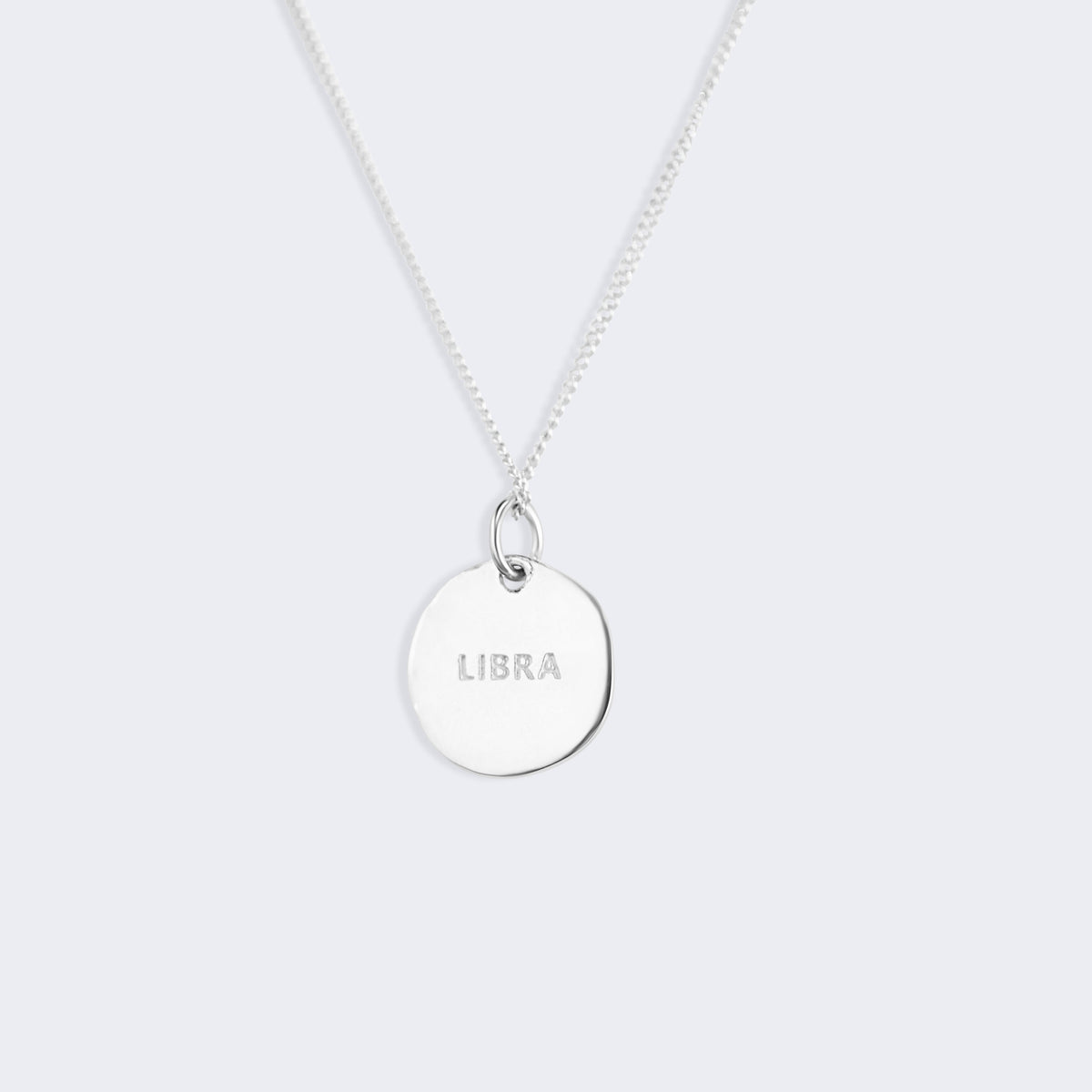 Close detail of the Libra constellation pendant, textured finish with small zircons marking the stars of the scales