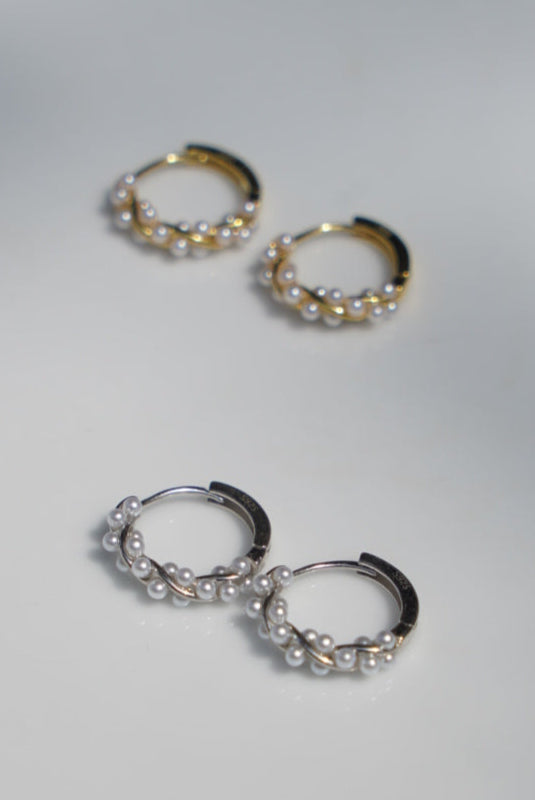 Pair of hoop earrings on a white surface