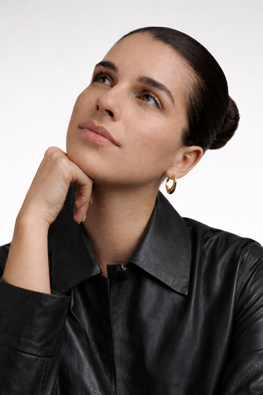Woman wearing bold chunks gold earrings 
