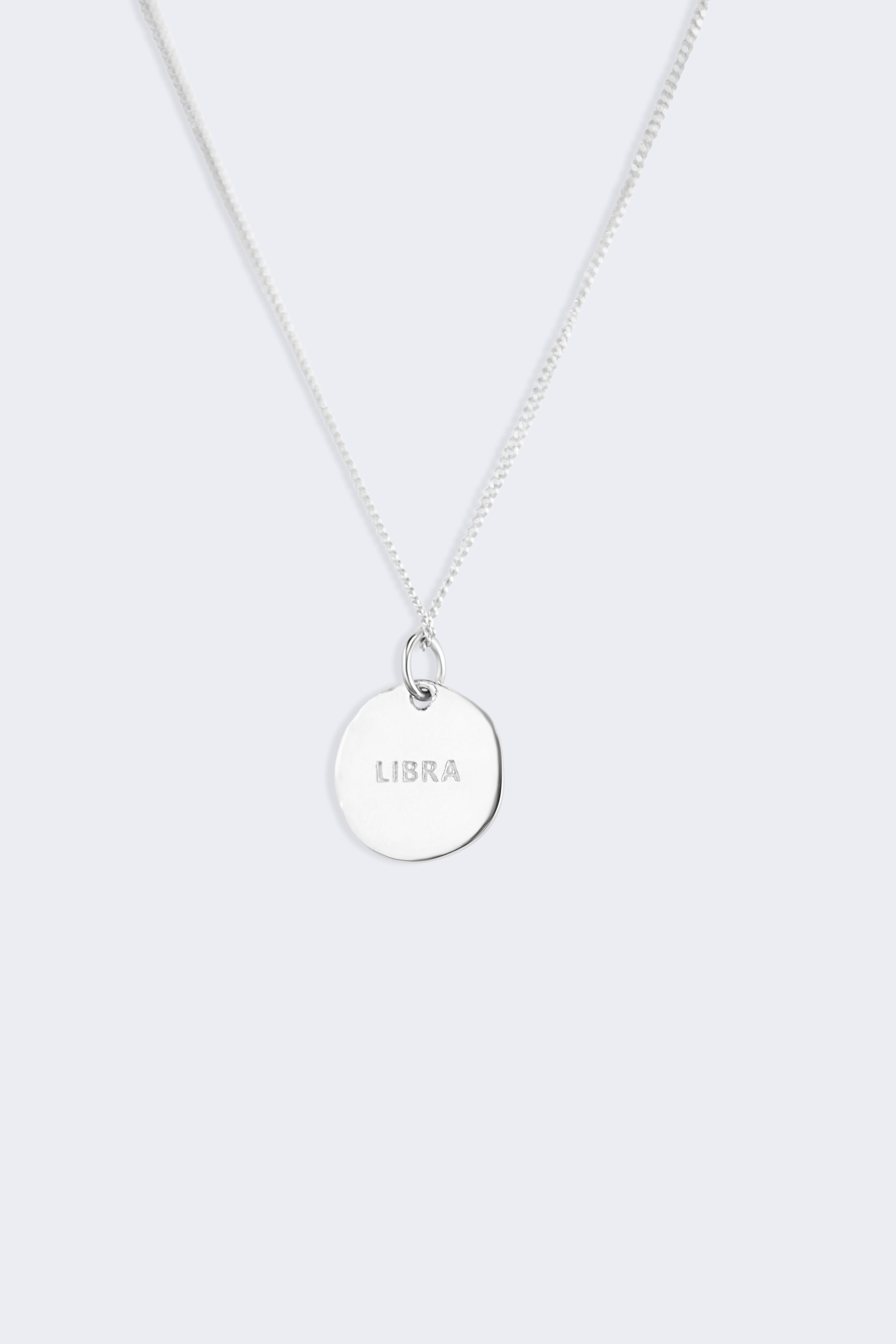 Close detail of the Libra constellation pendant, textured finish with small zircons marking the stars of the scales
