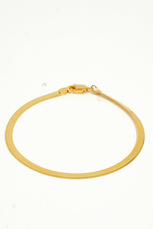 Gold bracelet on a white background